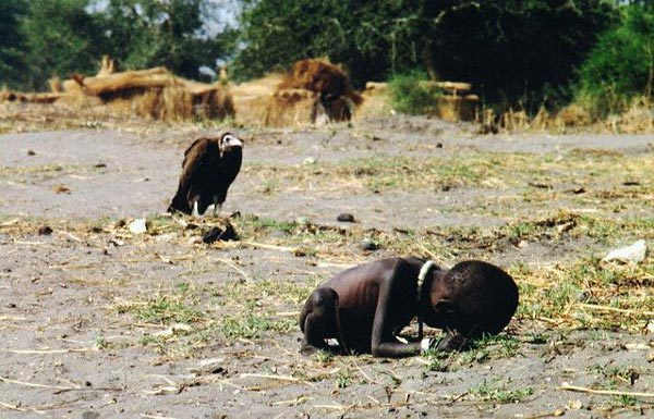 A vulture watches a starving child [1993] By Kevin Carter